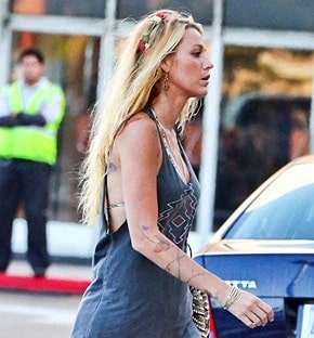 A picture of Blake Lively's temporary butterfly tattoo and wires on right forearm.